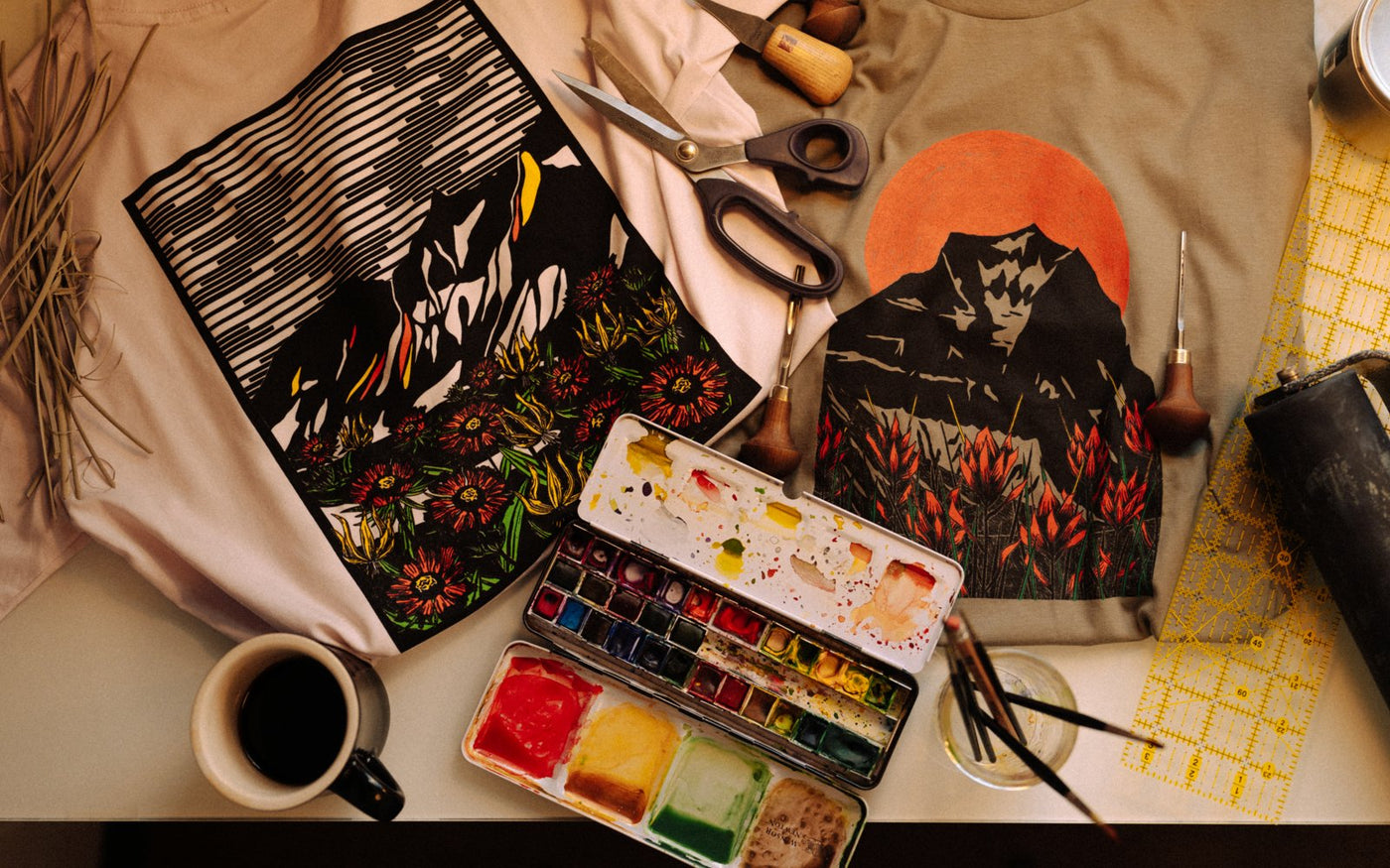 Woodcut series shirts with carving tools and watercolors on the workbench